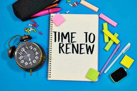  alarm clock with text TIME TO RENEW, written on notebook. Closeup of a personal Stock Photos