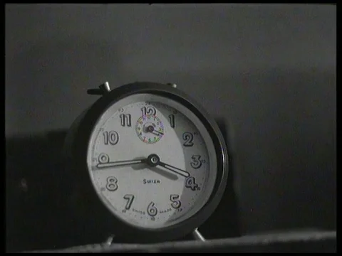 Alarm clock wakes up a man in bed, UK 1958 Vídeo Stock 136677504