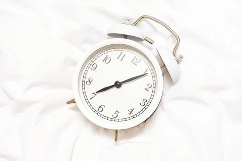 Alarm clock on white background close-up, early rise concept. Stock Photos