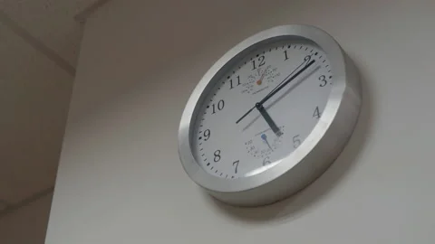 Alarm clock on white wall, time passing Stock Footage 194475420