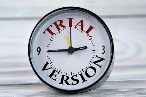 Alarm clock with words TRIAL VERSION on light wooden background close-up Stock Photos