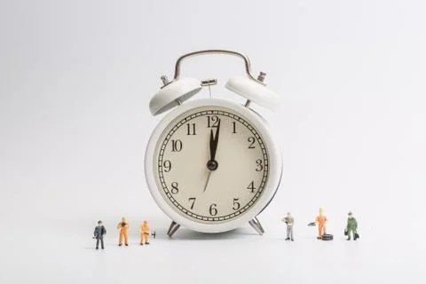 Alarm clock worker on white background Stock Photos