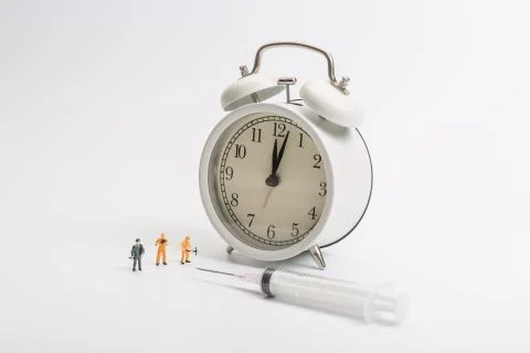 Alarm clock worker on white background Stock Photos