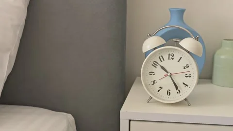 An alarm clock on your bedside table is ideal for waking up in morning. Feel the Stock Footage 276171023