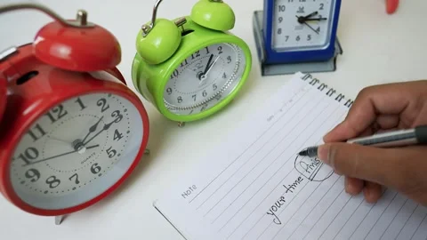 Alarm Clocks and Notebook for Time Management Stock Footage 318057196