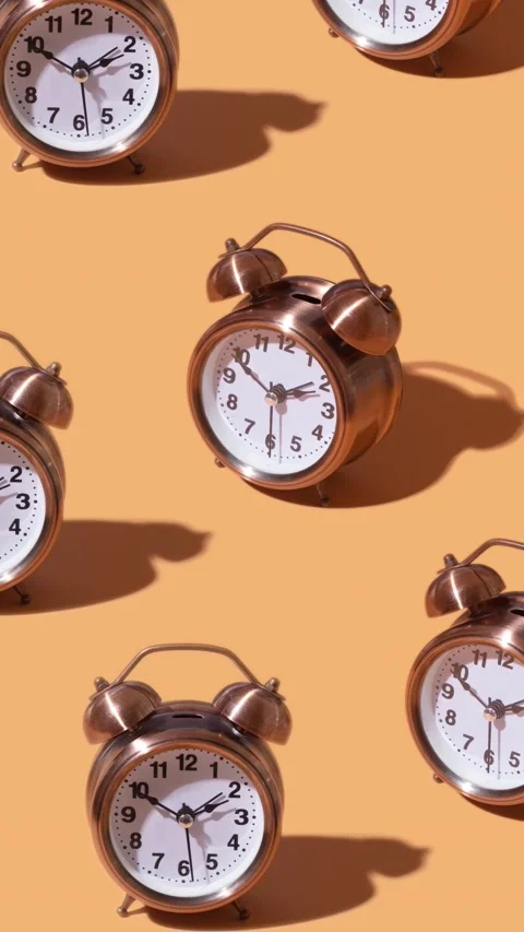 Alarm clocks moving on orange background Stock Footage 238762712