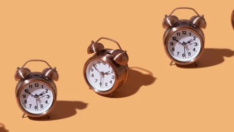 Alarm clocks moving on an orange background. Creative time concept Stock Footage 238762839