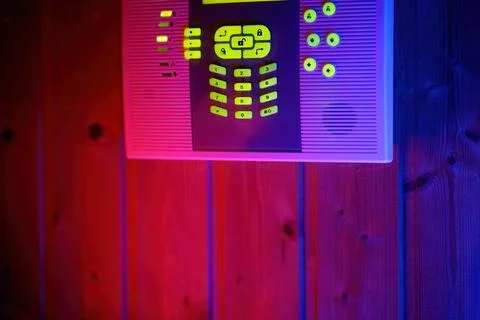 Alarm system control keypad with glowing green led at dark night Stock Photos