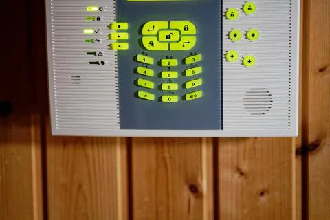 Alarm system control panel with glowing green led keyboard Stock Photos