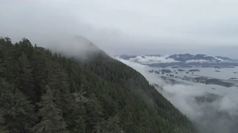 Alaska Aerial cloudy mountainside  view over lake Stock Footage 213880211