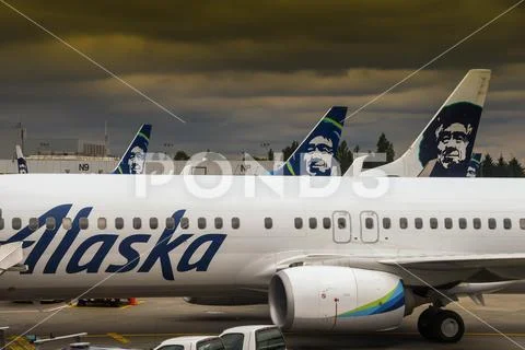 Alaska Airlines Boeing 737 jets and stormy sky at Seattle Stock Photos