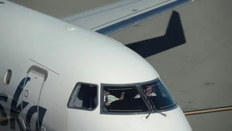 Alaska Airlines Flight Crew in Cockpit Approaching Terminal Stock Footage 331592855