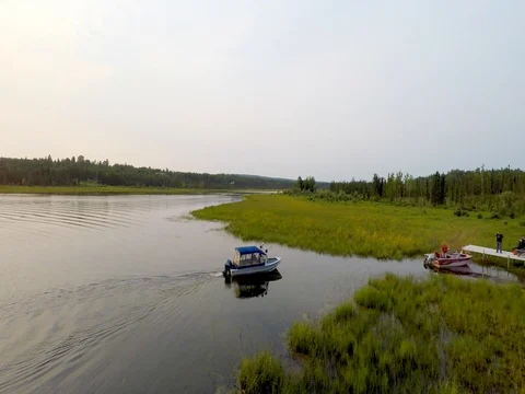 Alaska Moose River with boat heading for dock Stock Footage 78590918