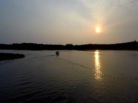 Alaska Moose River drone tracking over moving boat with sunset Stock Footage 78590776