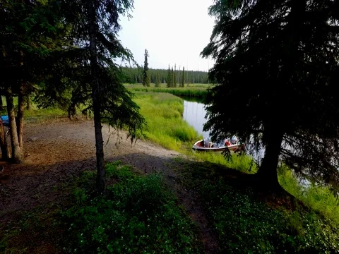 Alaska Moose River drone tracking over boat with river in background Stock Footage