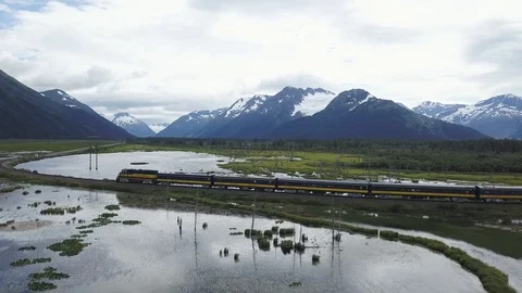 Alaska Railroad Train Passes lake near Portage Drone Aerial 4k Stock Footage 128937553