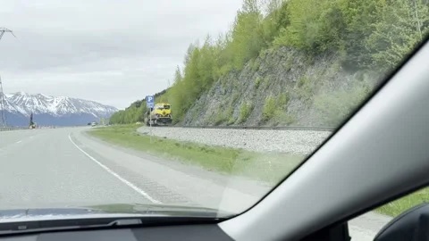 Alaska train with reflection of snowy mountains on Seward Hwy Stock Footage 283038770