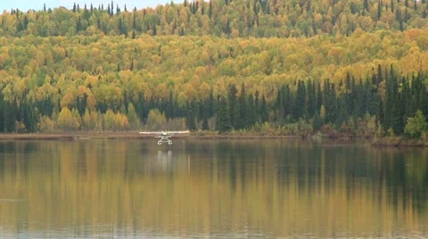 Alaskan float plane landing on remote lake in fall Stock Footage 40152660