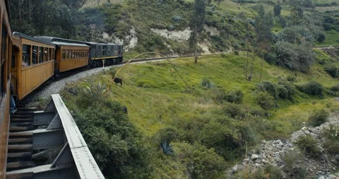 Alausi, Ecuador - March 3 2018: Train driving through farmland mountains Stock Footage 87215853
