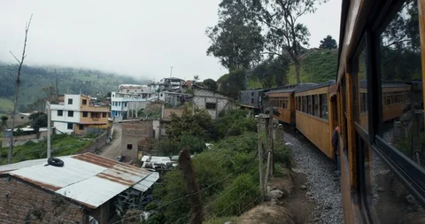 Alausi, Ecuador - March 3 2018: Train approaching village in Andes mountains Stock Footage 87215912