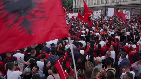 Albanian flag waving crowd marching on Tirana street to protest luxury real Stock Footage 338033091