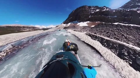 Alberta, Cananda, 17 March 2020: A kayaker who paddles in a river avoiding the r Video stock 164897554