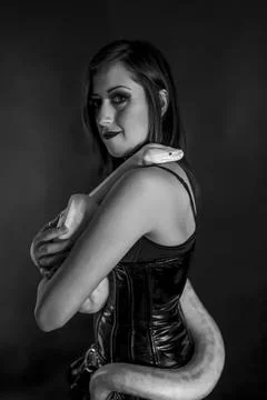 Albino molur python with a dark goth brunette girl 写真素材
