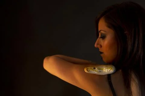 Albino molur python with a dark goth brunette girl 写真素材