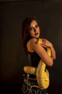 Albino molur python with a dark goth brunette girl Foto stock