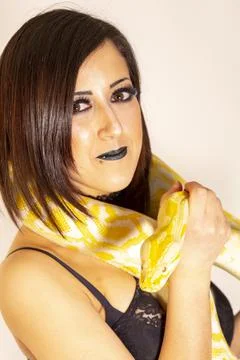 Albino molur python with a dark goth brunette girl 写真素材