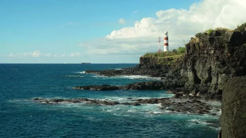 Albion Lighthouse at Pointe aux Caves, Mauritius, towers over the rocks 库存影片 141942560