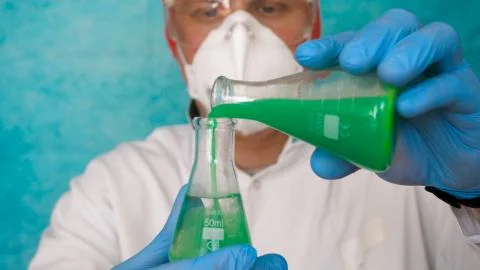 The alchemist checks the test tubes with a test of different compositions. Stock Photos