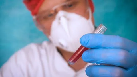 The alchemist checks the test tubes with a test of different compositions. Stock Photos