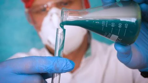 The alchemist checks the test tubes with a test of different compositions. Stock Photos
