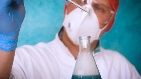 The alchemist checks the test tubes with a test of different compositions. Stock Photos