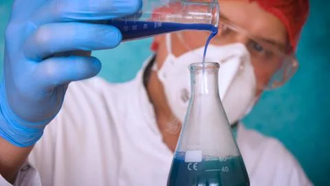 The alchemist checks the test tubes with a test of different compositions. Stock Photos