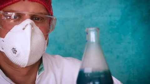 The alchemist checks the test tubes with a test of different compositions. Stock Photos