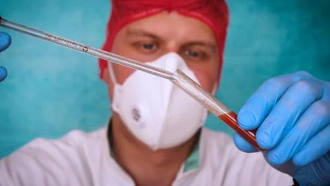 The alchemist checks the test tubes with a test of different compositions. Stock Photos