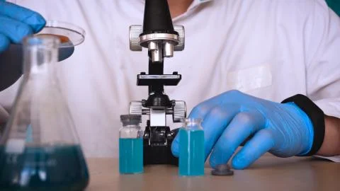 The alchemist checks the test tubes with a test of different compositions. Stock Photos