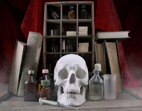 Alchemy table with skull. Stock Photos