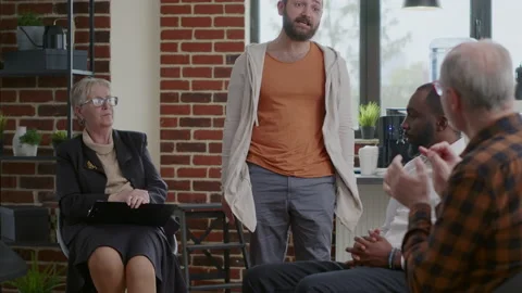 Alcohol addict with desperate behavior having breakdown at aa therapy meeting Stock Footage 165157187
