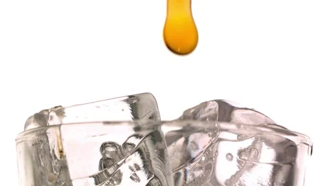 Alcohol being poured on the ice cubes in slow motion Stock Footage 81229403