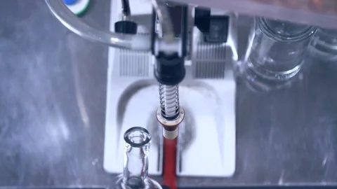 Alcohol bottle being filled at distillery during bottling process Stock-Footage 87119829