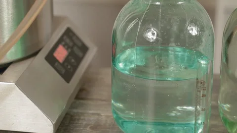 Alcohol dripping into a jar. Last step of a Distillery Where Final Product of Stock Footage 129708525