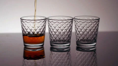 Alcohol Pouring Into Glasses Closeup Stock Footage 132909513