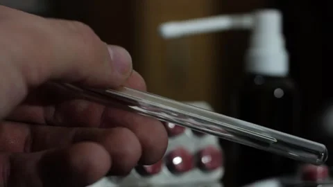 Alcohol thermometer in hand Stock Footage 258795633