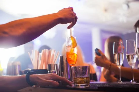 Alcoholic beverage based on table with ice cubes and oranges. Stock Photos