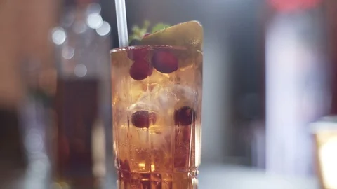 Alcoholic coctail with lime, raspberry and mint into beautiful glass Stock Footage 96147078