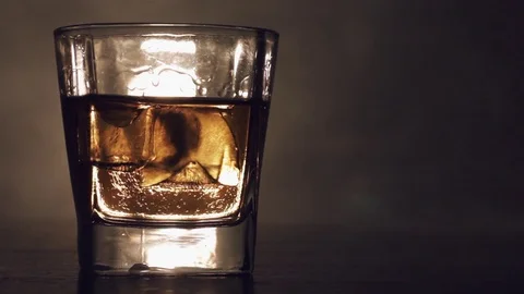 Alcoholic drink with ice cubes in a cold glass Stock Footage 81049913