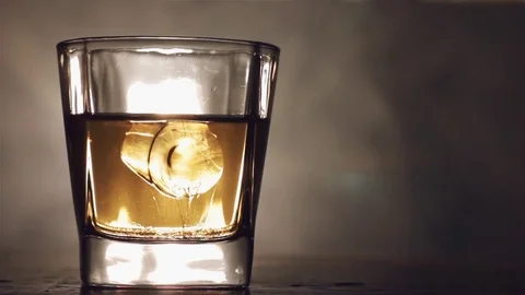 Alcoholic drink with ice cubes in a cool glass Stock Footage 81083067